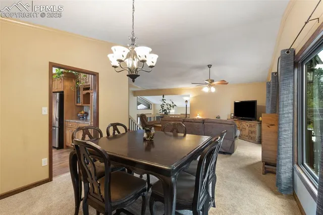 a view of a dining room with furniture and chandelier
