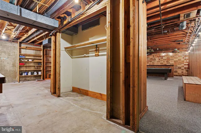 a view of walk in closet with clothes