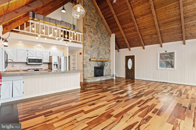 a view of a room with wooden floor and staircase