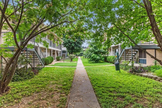 a view of a pathway with a house in the background