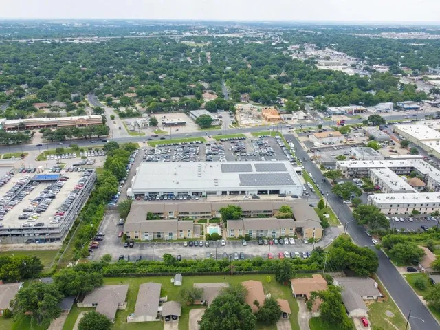 an aerial view of residential houses with outdoor space and river