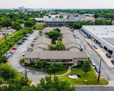 an aerial view of a house with a garden and lake view
