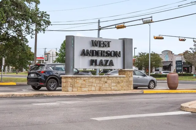 a view of parking with a car parked on the road