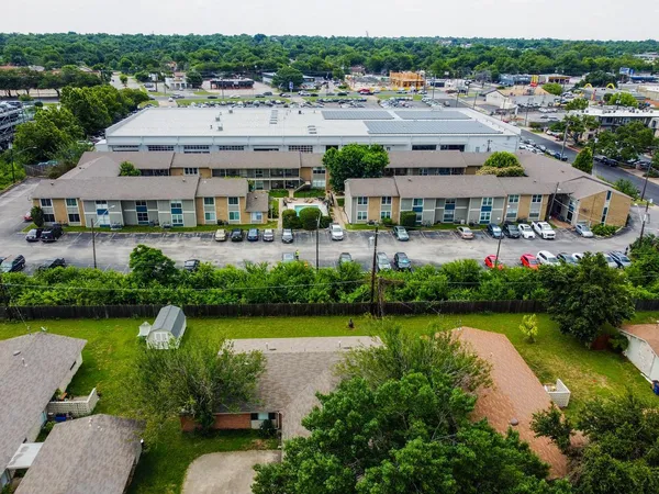 an aerial view of residential houses with outdoor space
