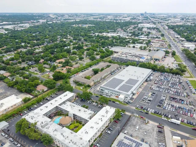 an aerial view of residential houses with outdoor space