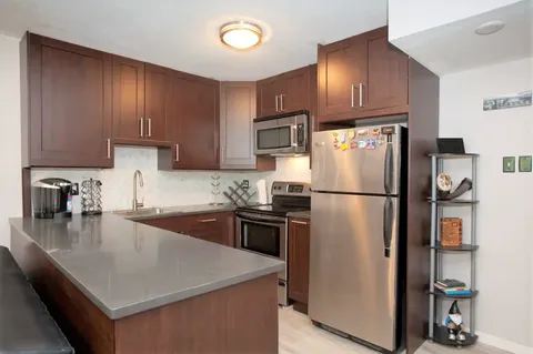 a kitchen with a refrigerator a stove a sink and a refrigerator