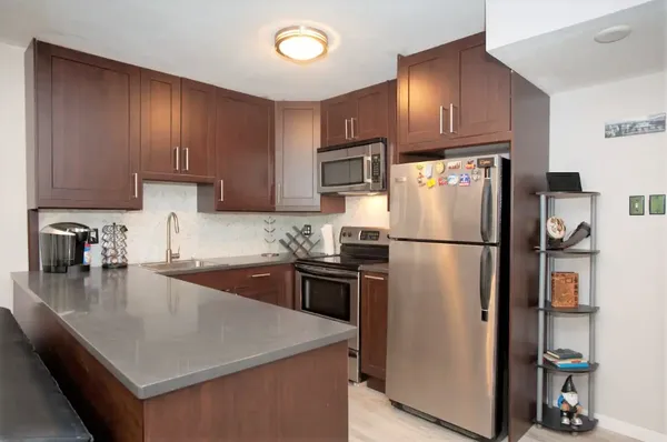 a kitchen with a refrigerator a stove a sink and a refrigerator