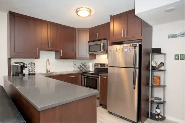 a kitchen with a refrigerator a stove a sink and a refrigerator