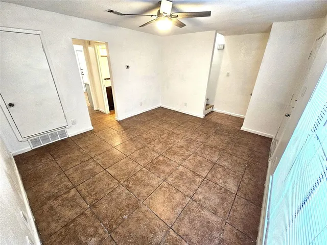 a view of a livingroom with wooden floor and entryway