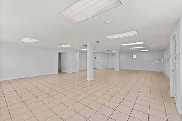 an empty room & view of bathroom