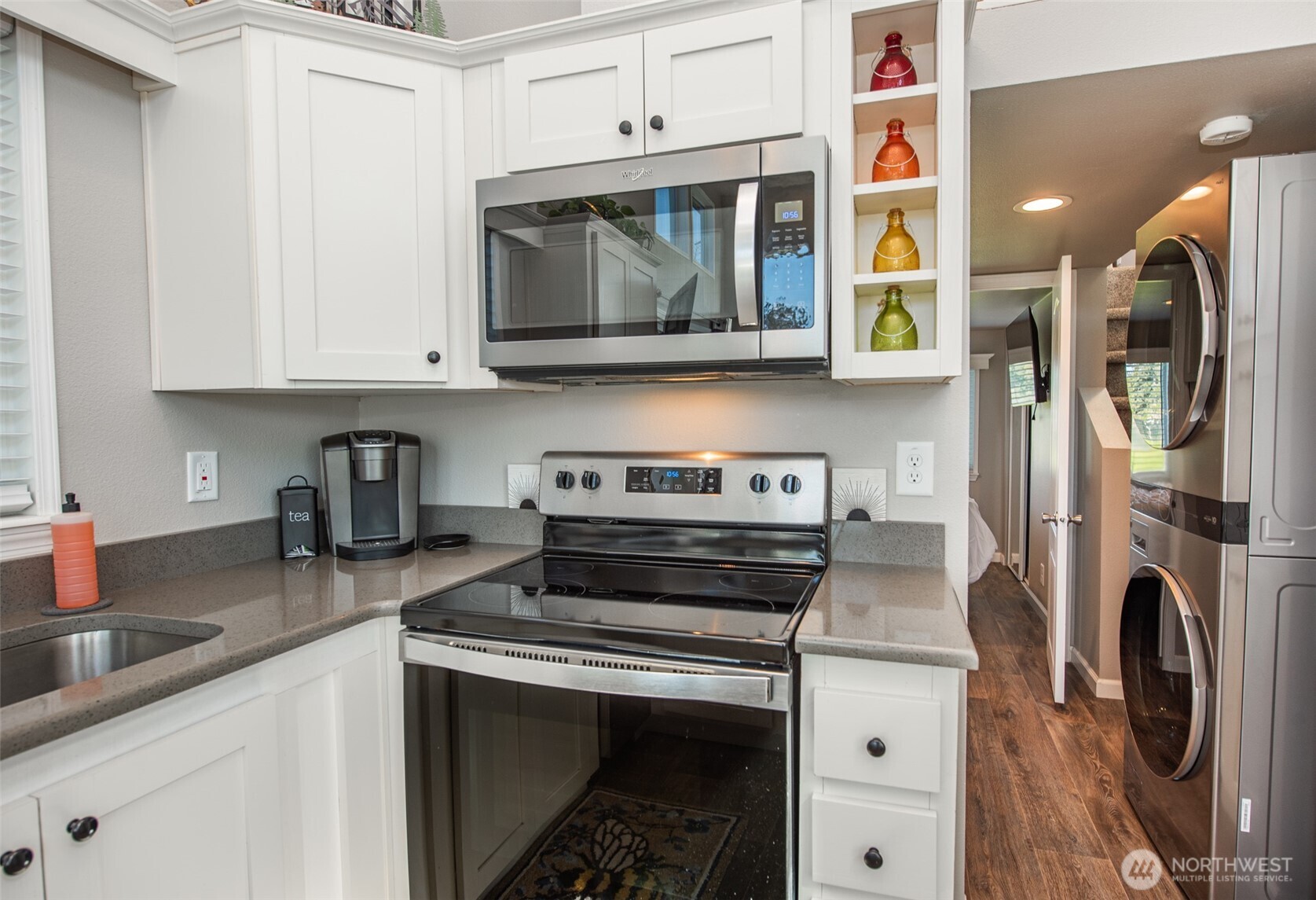 82 Williamson Road Sequim, WA 98382 - Photo 15 of 40 a kitchen with stainless steel appliances a stove a microwave a sink and cabinets