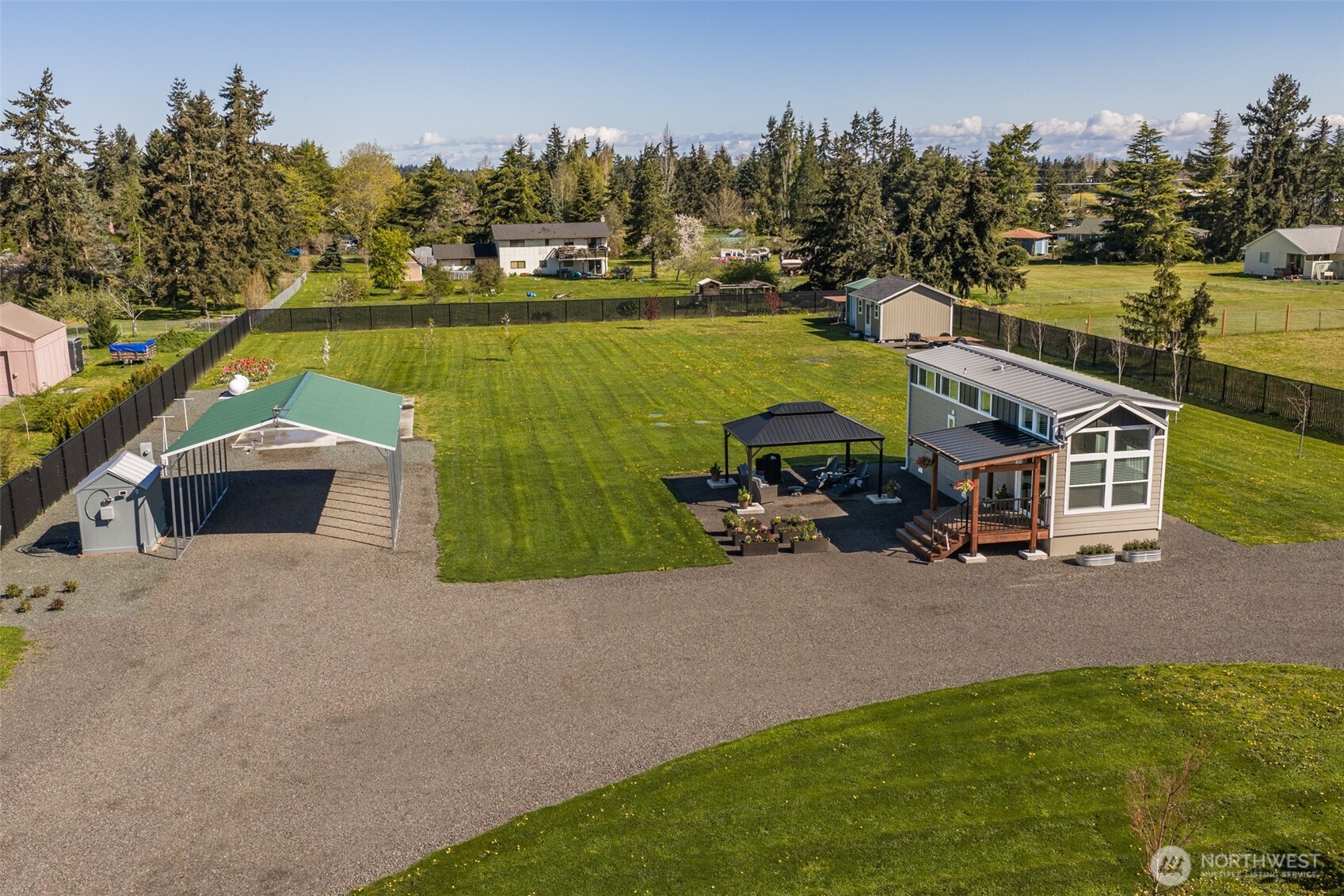 82 Williamson Road Sequim, WA 98382 - Photo 2 of 40 an aerial view of a house with a garden and lake view
