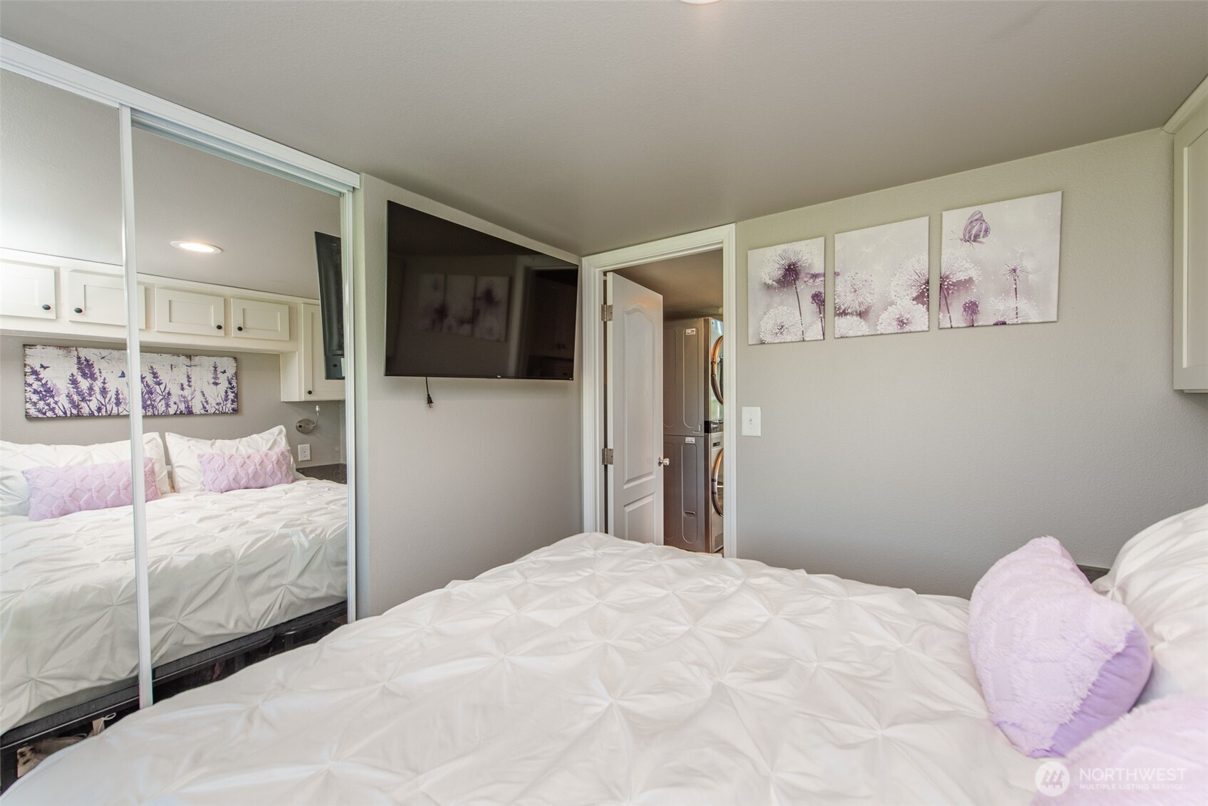 82 Williamson Road Sequim, WA 98382 - Photo 24 of 40 a bedroom with a bed and a flat screen tv