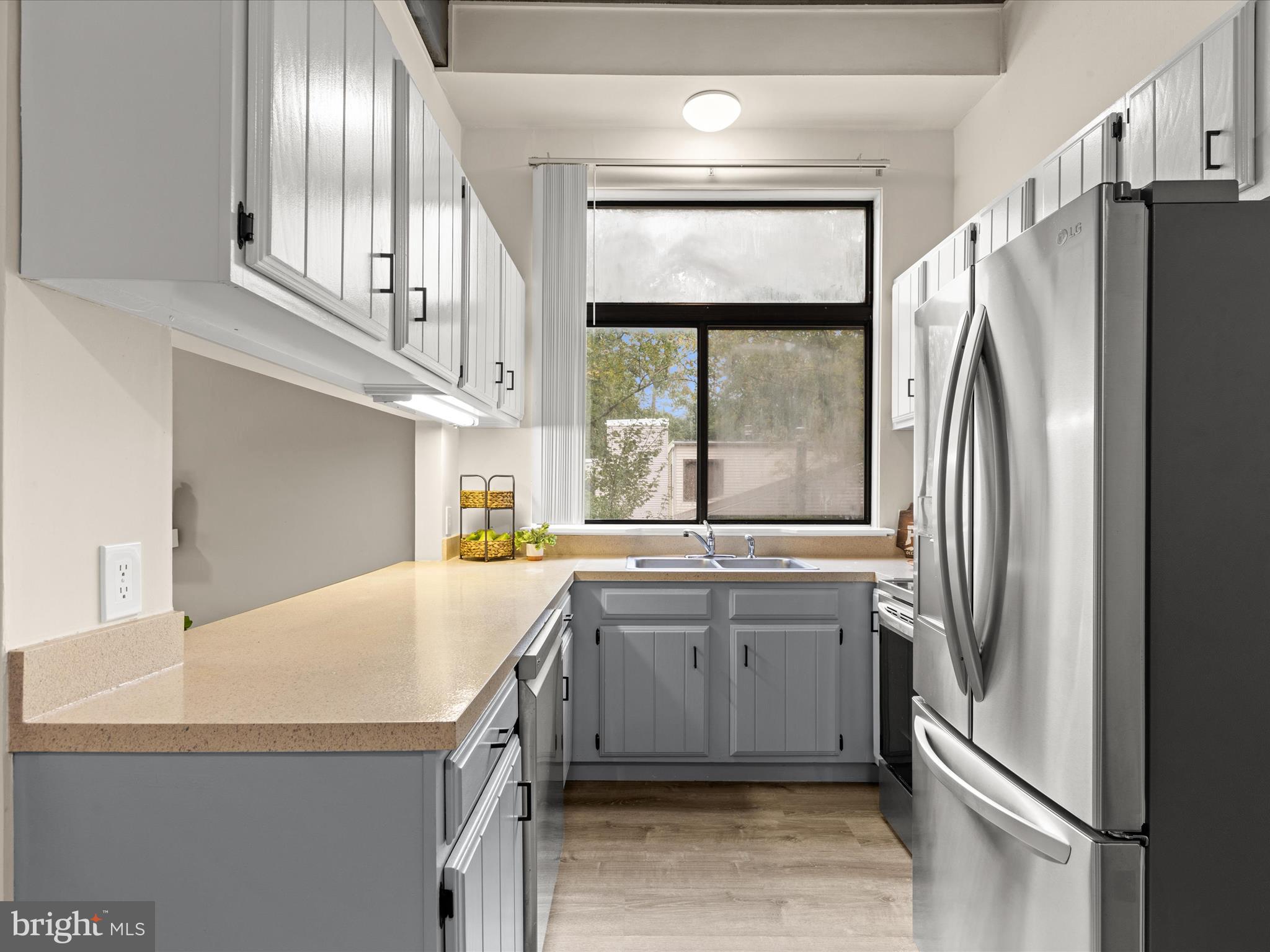 438 Ocean Parkway, Unit 4 Berlin, MD 21811 - Photo 13 of 81 a kitchen with a refrigerator a sink and windows