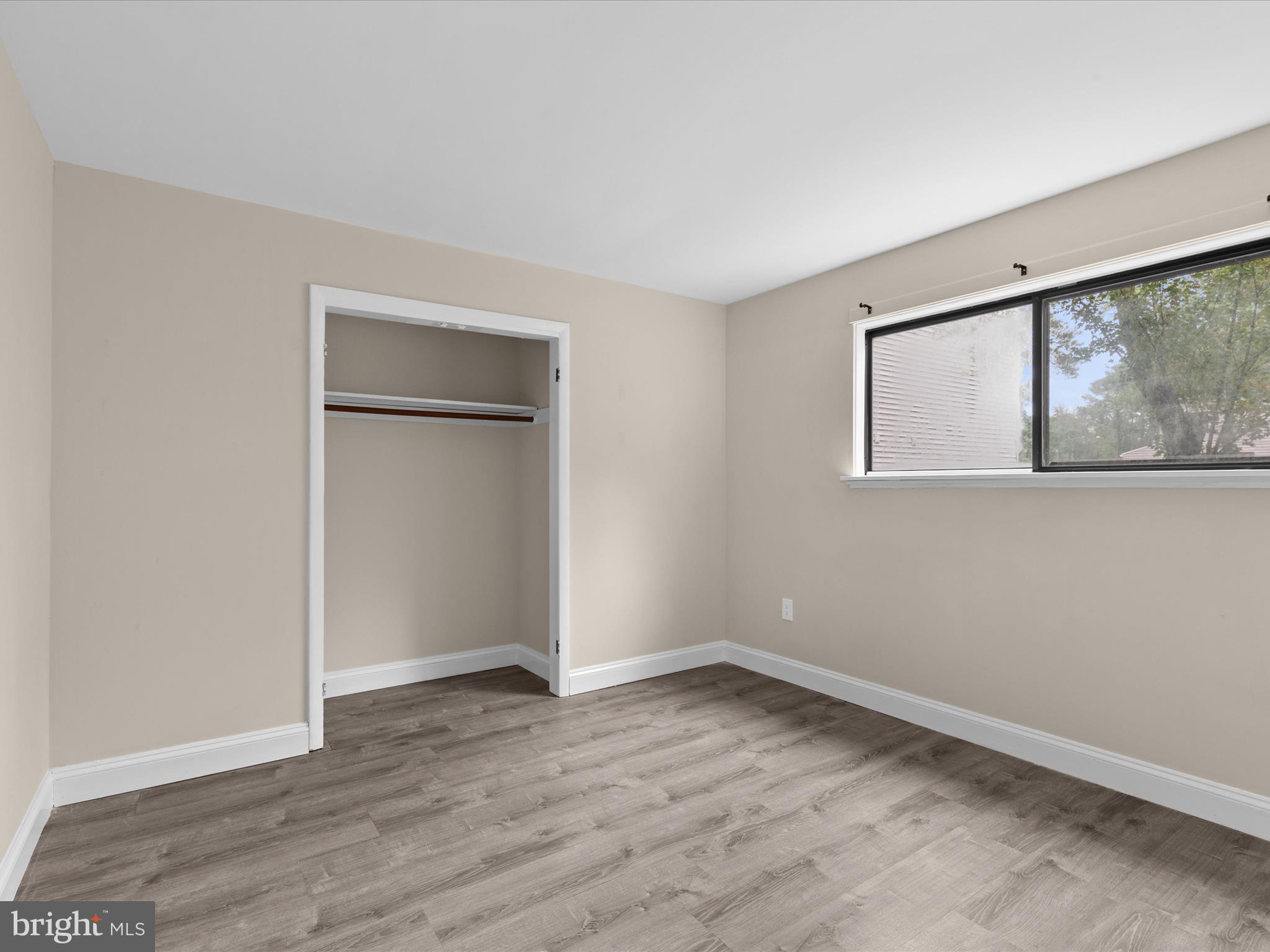 438 Ocean Parkway, Unit 4 Berlin, MD 21811 - Photo 34 of 81 an empty room with wooden floor and windows