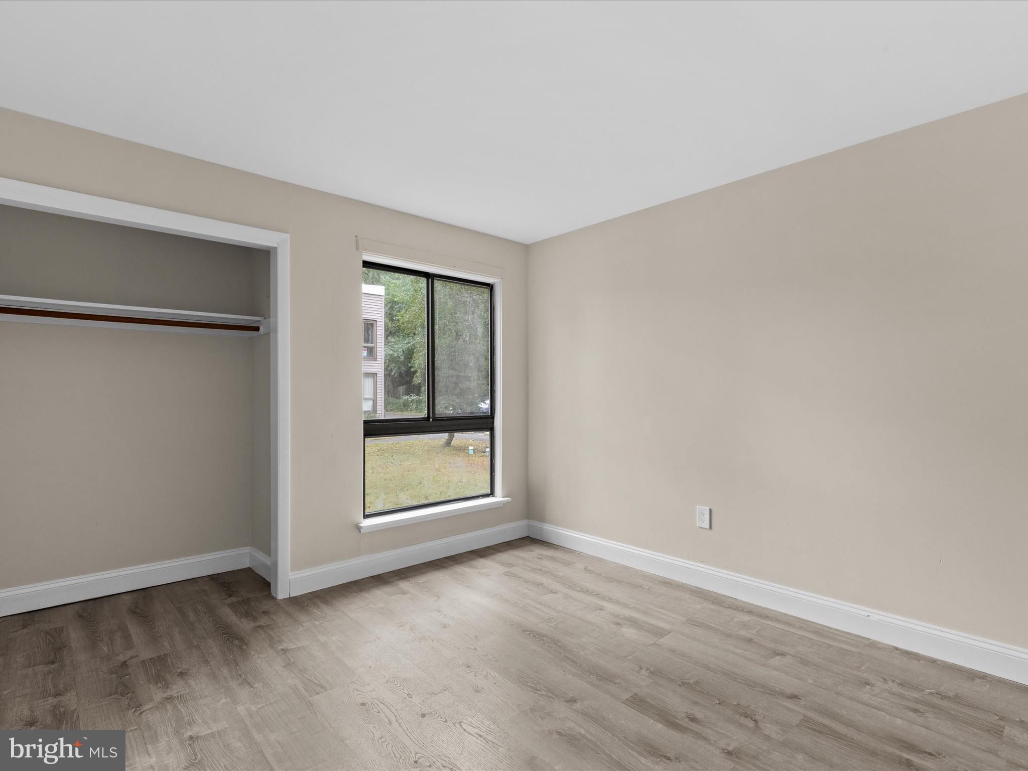 438 Ocean Parkway, Unit 4 Berlin, MD 21811 - Photo 37 of 81 an empty room with wooden floor and windows