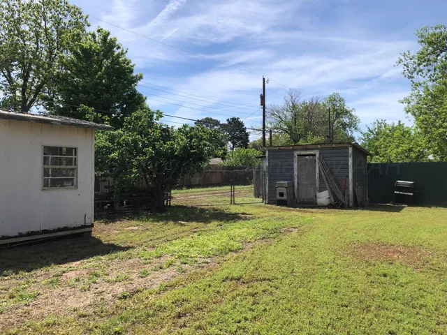 a backyard of a house with yard and outdoor seating