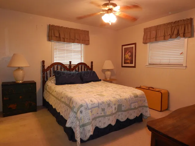 a white toilet sitting next to a shower
