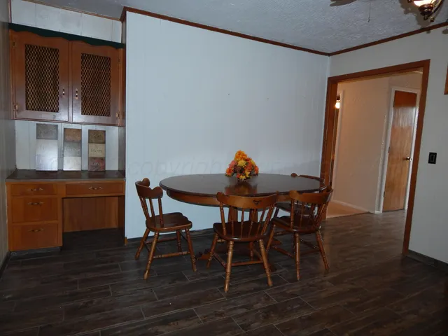 a dining room with furniture and wooden floor