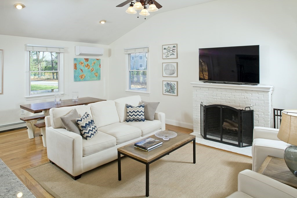4 Polk Road Hingham, MA 02043 - Photo 5 of 21 a living room with furniture a flat screen tv and a fireplace
