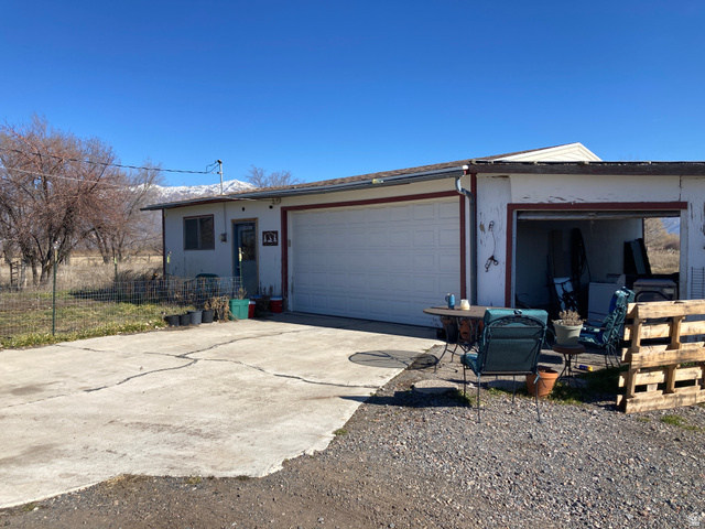 200 South 2800th Street West Ogden, UT 84404 - Photo 21 of 42 View of front of house featuring concrete driveway, an attached garage, and stucco siding