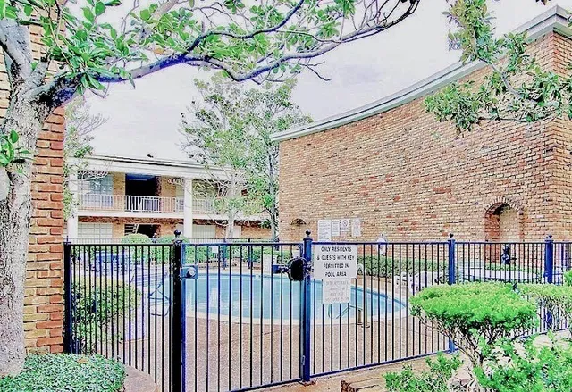 a view of a house with a small yard and wooden fence