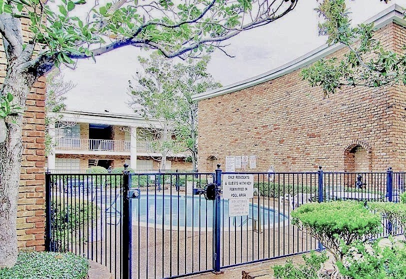 2121 Fountain View Drive, Unit 18 Houston, TX 77057 - Photo 12 of 13 a view of a house with a small yard and wooden fence