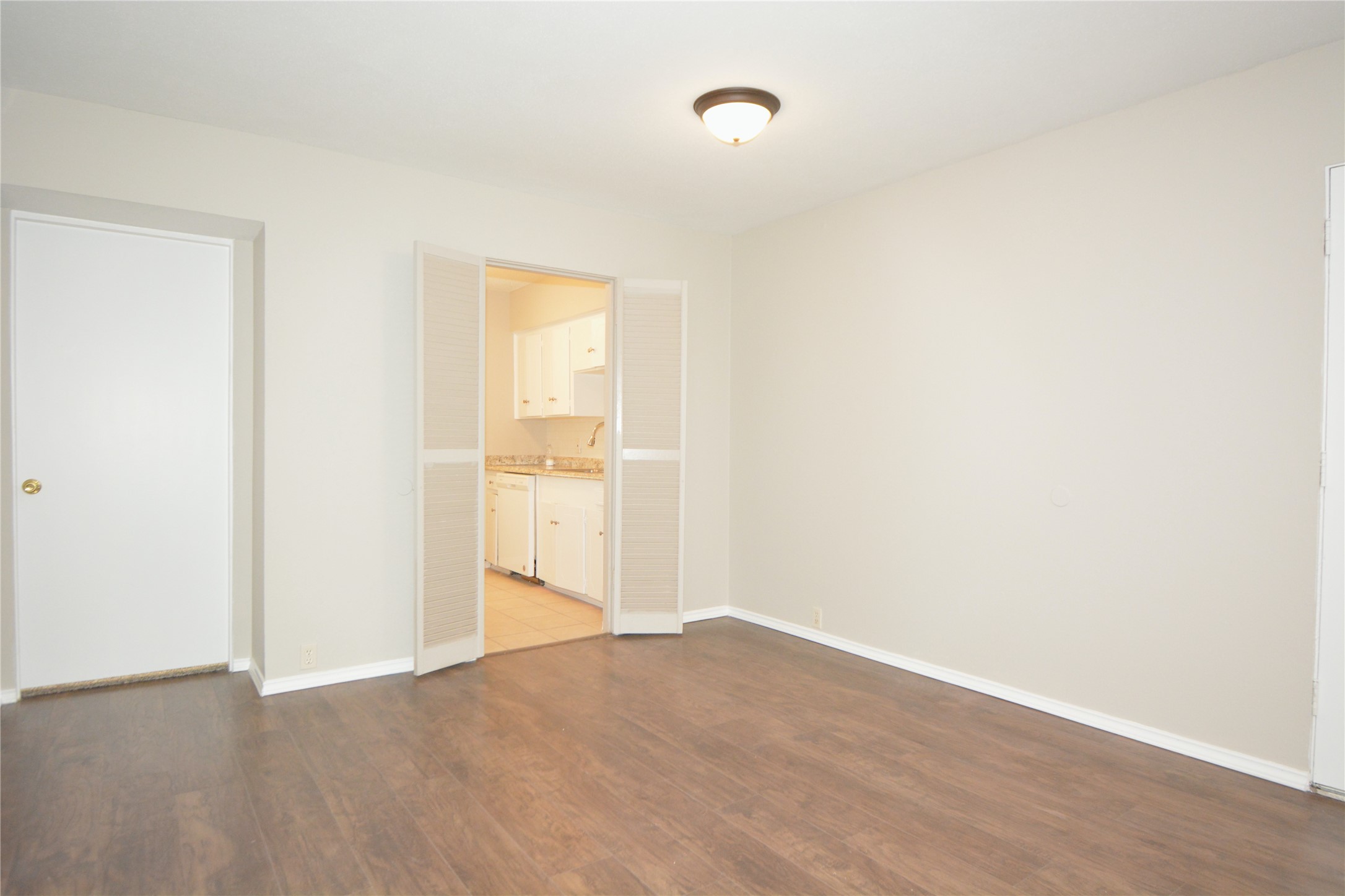 2121 Fountain View Drive, Unit 18 Houston, TX 77057 - Photo 4 of 13 a view of empty room with wooden floor and fan
