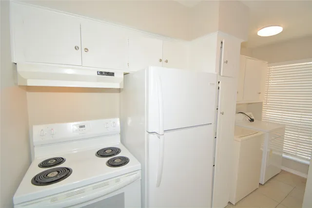 a white refrigerator freezer sitting inside of a kitchen