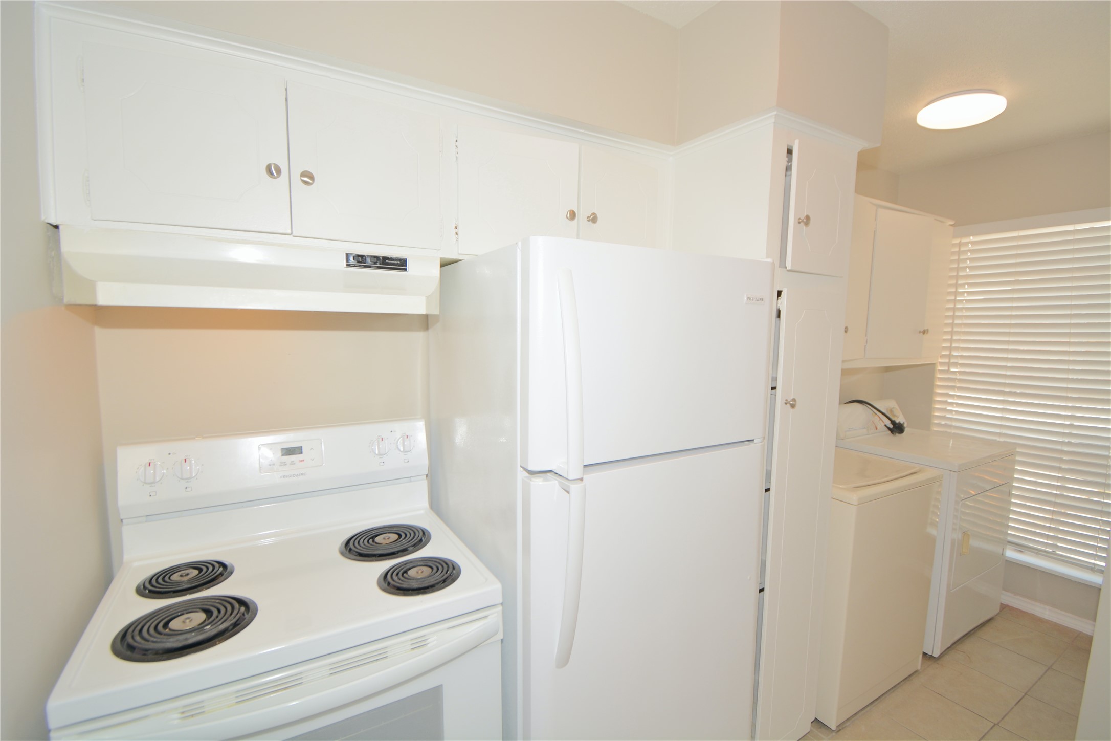 2121 Fountain View Drive, Unit 18 Houston, TX 77057 - Photo 5 of 13 a white refrigerator freezer sitting inside of a kitchen