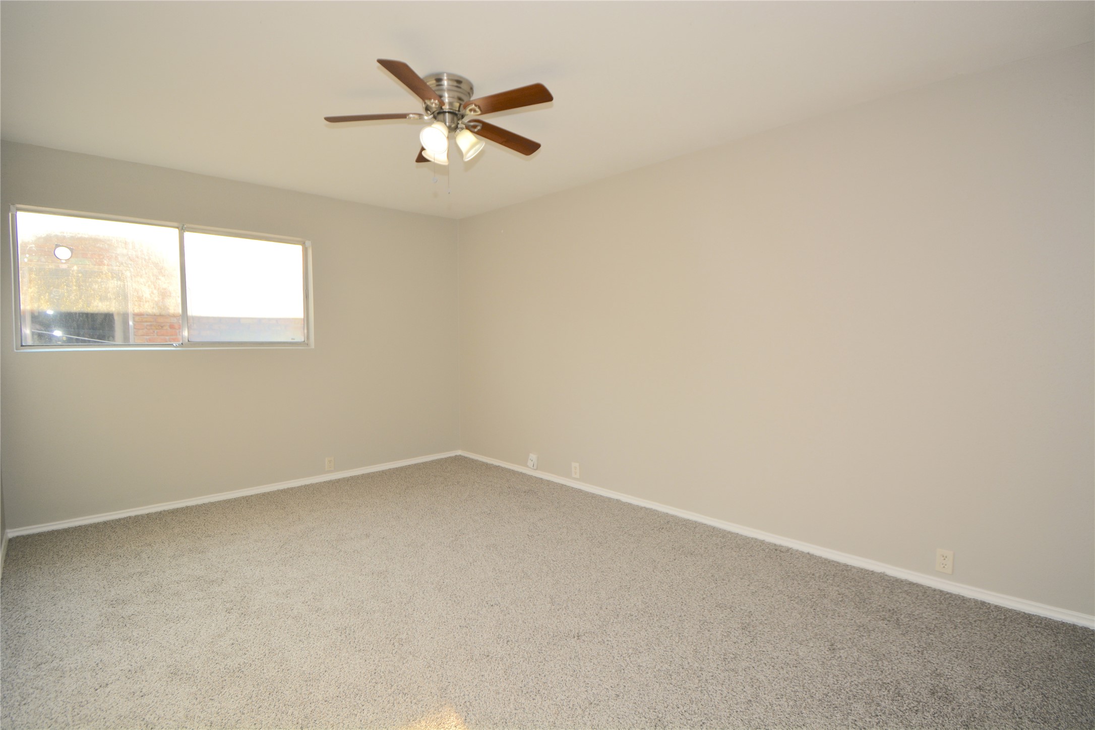 2121 Fountain View Drive, Unit 18 Houston, TX 77057 - Photo 6 of 13 an empty room with a window and a fan