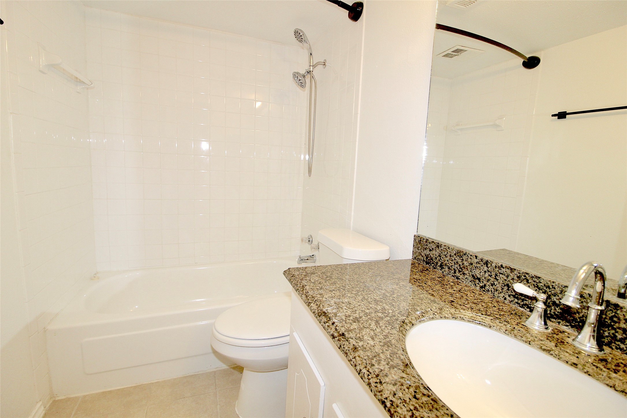 2121 Fountain View Drive, Unit 18 Houston, TX 77057 - Photo 7 of 13 a bathroom with a granite countertop sink toilet and shower