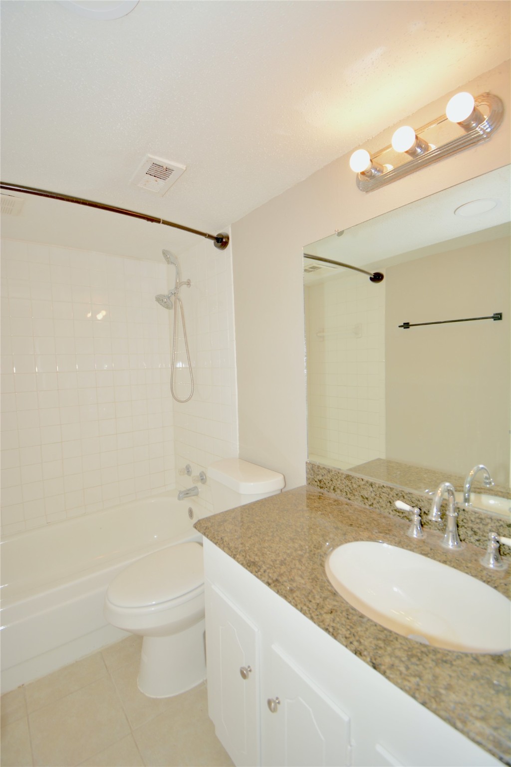2121 Fountain View Drive, Unit 18 Houston, TX 77057 - Photo 9 of 13 a bathroom with a granite countertop sink a toilet and shower