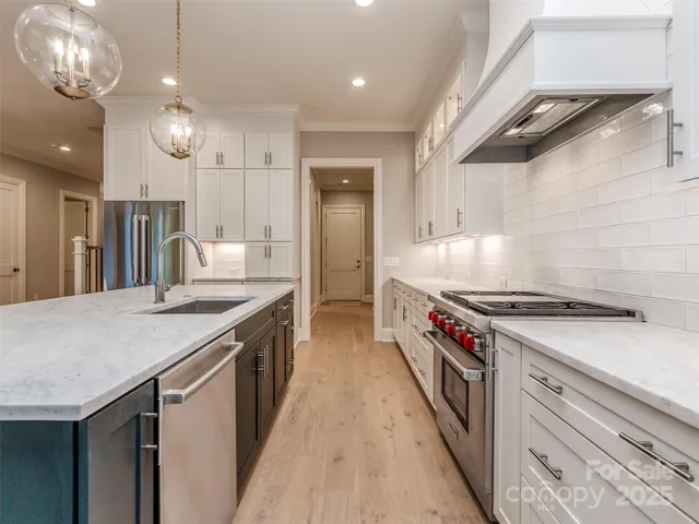 a kitchen with granite countertop a sink and a stove