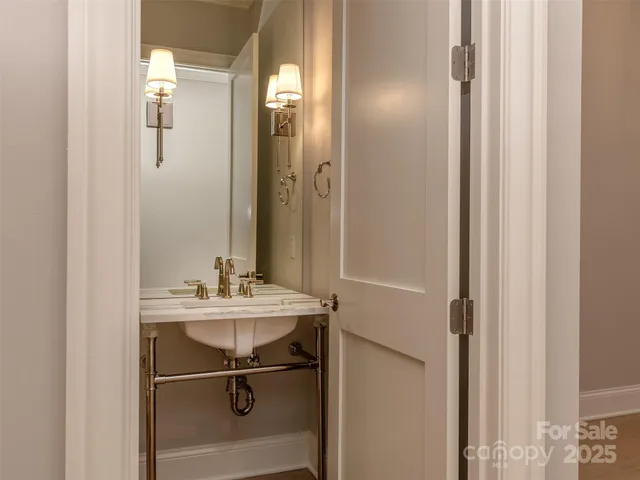 a bathroom with a sink mirror and vanity
