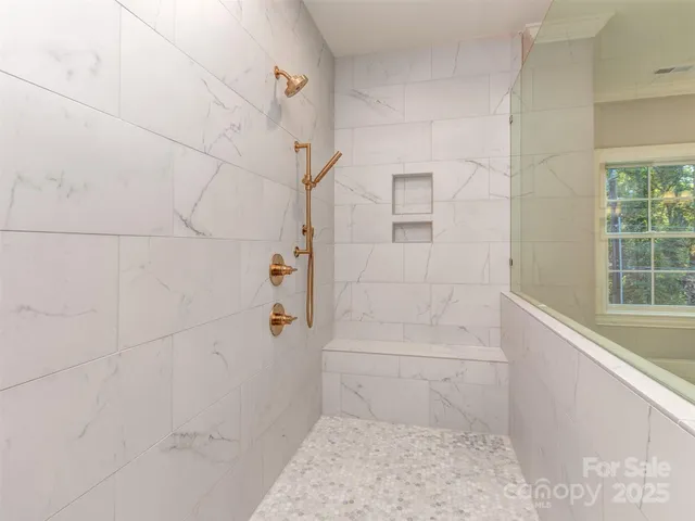 a bathroom with bathtub and shower