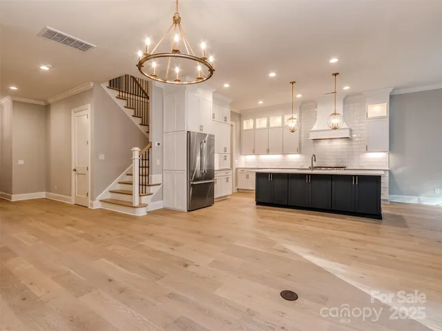 a view of kitchen and hall with wooden floor