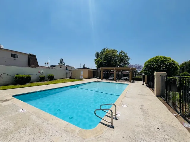 a view of a house with backyard and sitting area