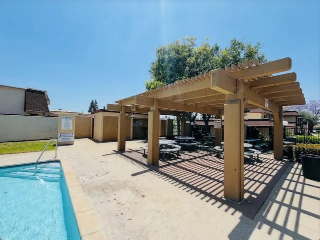a view of a patio with table and chairs and potted plants
