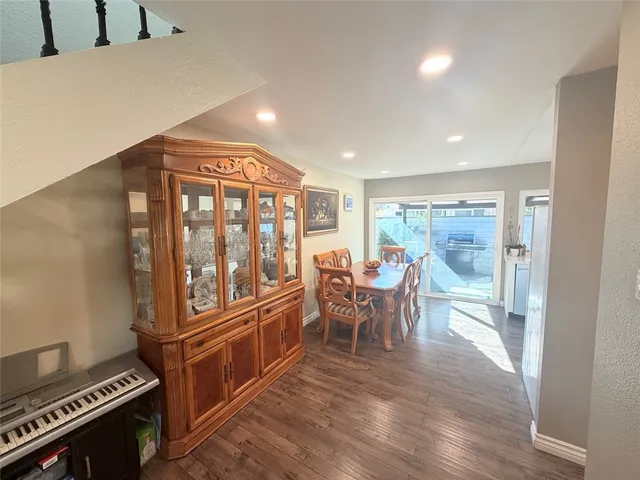 a view of a dining room with furniture a chandelier and wooden floor