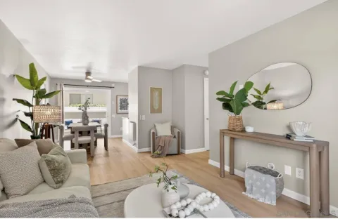 a living room with furniture flowers and a chandelier