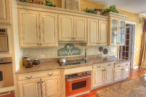 24145 West Milton Road Hawthorn Woods, IL 60047 - Photo 7 of 16 a kitchen with stainless steel appliances granite countertop a stove a sink and cabinets