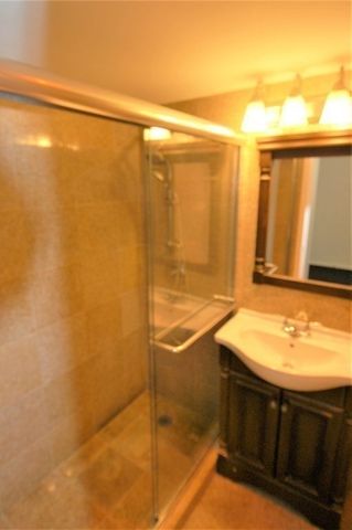 a bathroom with a sink a toilet and mirror