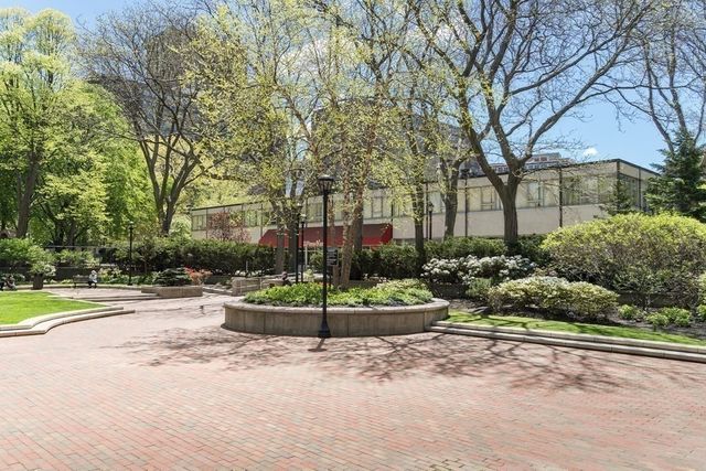 a front view of a house with a yard and potted plants