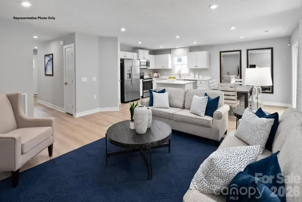 a living room with furniture or kitchen and a wooden floor