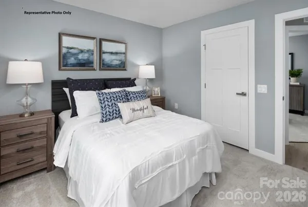 a bedroom with bed and wall painting