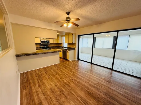 a kitchen with granite countertop a sink stove and refrigerator