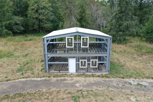 a view of a barn in the middle of a yard