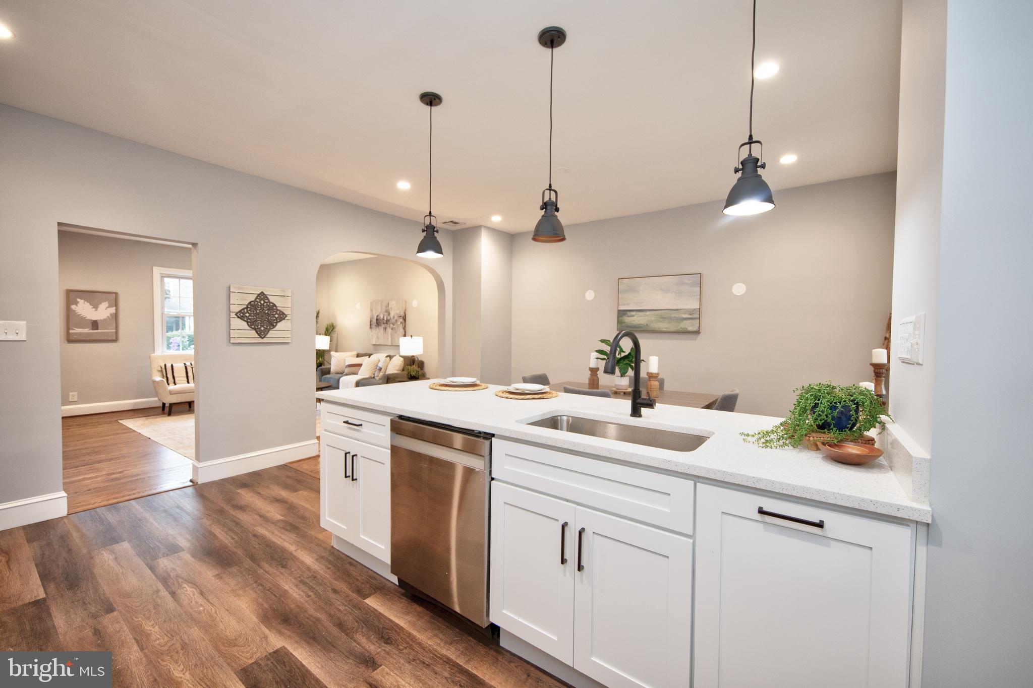 416 Dunkirk Road Baltimore, MD 21212 - Photo 12 of 33 a kitchen with a sink chandelier and wooden floor