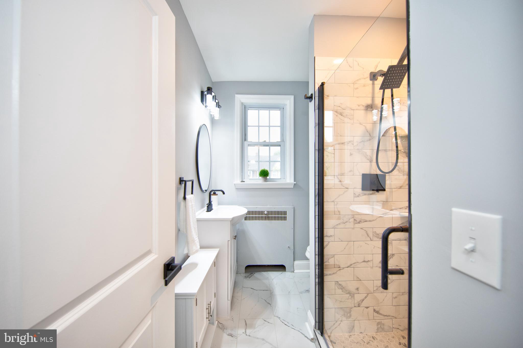 416 Dunkirk Road Baltimore, MD 21212 - Photo 14 of 33 a bathroom with a sink a toilet and shower